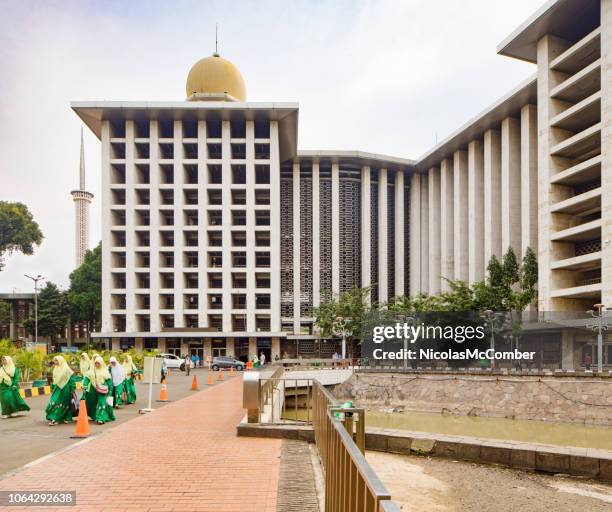 jakarta national istiqlal mosque side view with group of women walking - islam temple stock pictures, royalty-free photos & images