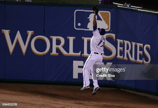 Nelson Cruz of the Texas Rangers makes a catch for an out on a deep fly ball hit by Buster Posey of the San Francisco Giants in the sixth inning of...