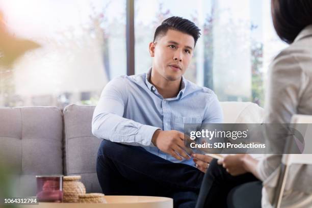 attentive man listens to counselor - alternative therapy stock pictures, royalty-free photos & images