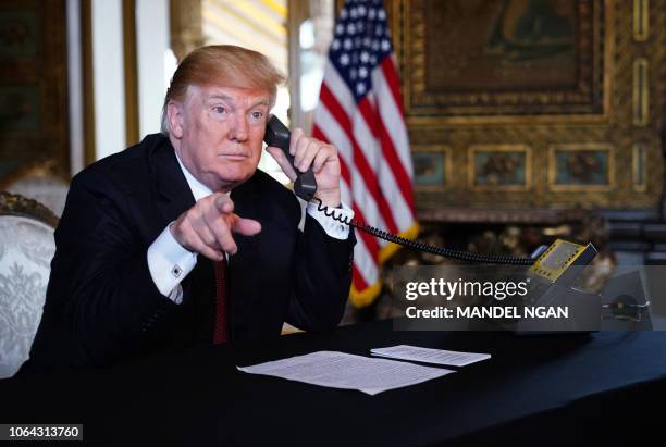 President Donald Trump speaks to members of the military via teleconference from his Mar-a-Lago resort in Palm Beach, Florida, on Thanksgiving Day,...