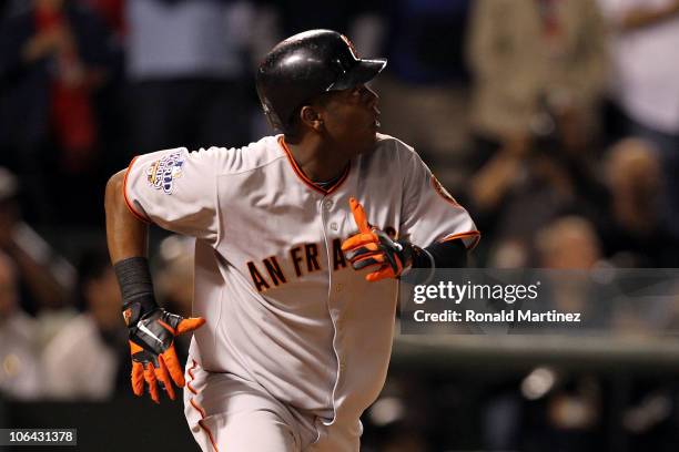 Edgar Renteria of the San Francisco Giants watches the ball as he runs to first on his 3-run home run in the seventh inning against Cliff Lee of the...