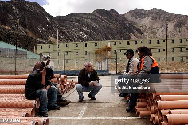 Bloomberg News reporter Elliot Smith, center, interviews painters at a former state-owned mine camp that is now owned by Aluminum Corp. Of China,...