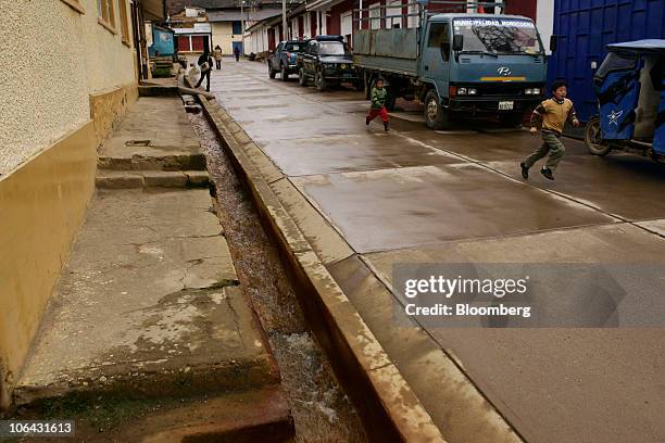 Children run along the only paved street in Morococha, Peru, on Monday, April 5, 2010. Aluminum Corp. Of China, known as Chinalco, a Chinese...