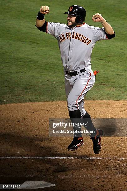 Cody Ross of the San Francisco Giants celebrates after he scored on a 3-run home run hit by Edgar Renteria in the seventh inning against the Texas...