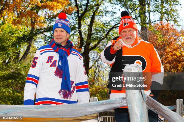 Former New York Ranger Mike Richter and Former Philadelphia Flyer Bernie Parent waves at fans as they ride the 2018 Discover NHL Thanksgiving...