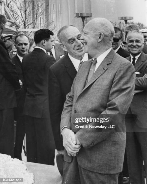 Flushing Meadows, N.Y.: Former President Dwight D. Eisenhower laughs with Robert Moses while visiting the Churchill Pavilion at the World's Fair in...