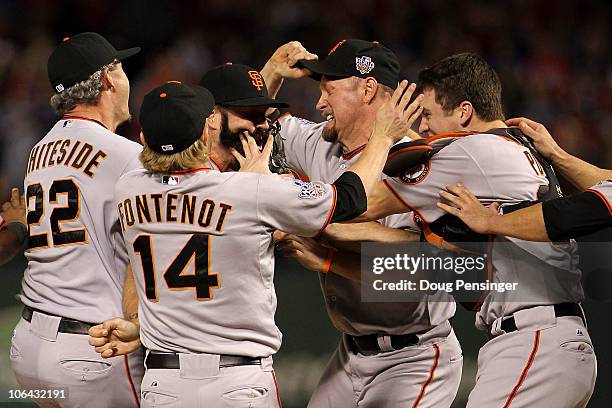 Brian Wilson and catcher Buster Posey of the San Francisco Giants celebrate with their teammates after the Giants won 3-1 against the Texas Rangers...