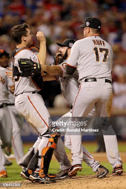 Buster Posey, Brian Wilson and Aubrey Huff of the San Francisco Giants celebrate after the Giants won 3-1 against the Texas Rangers in Game Five of...
