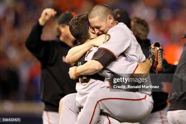 Buster Posey hugs Aubrey Huff of the San Francisco Giants celebrate their 3-1 victory to win the World Series over the Texas Rangers in Game Five of...