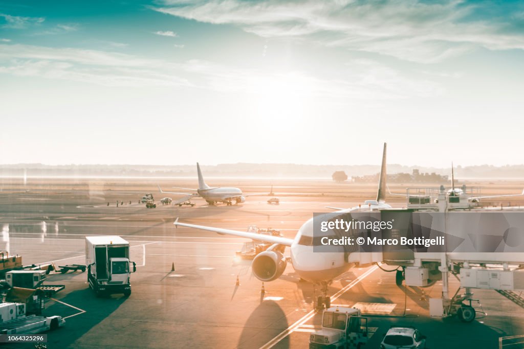 Airplanes in an airport at sunrise