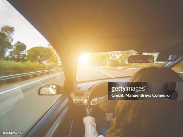 woman driving her car - cars on motor way stock-fotos und bilder