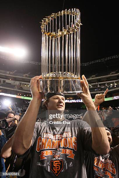 Matt Cain of the San Francisco Giants celebrates with the World Series Championship trophy out to the field after they won 3-1 against the Texas...