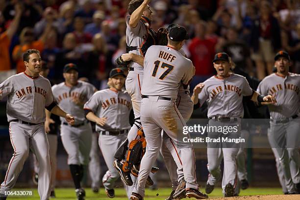 Pat Burrell, Buster Posey and Aubrey Huff of the San Francisco Giants celebrates their 3-1 victory to win the World Series over the Texas Rangers in...