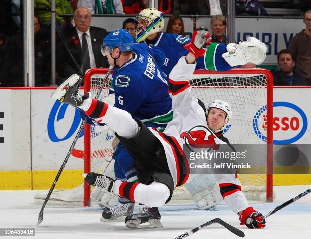 David Clarkson of the New Jersey Devils gets tripped up by Christian Ehrhoff of the Vancouver Canucks during their game Rogers Arena on November 1,...