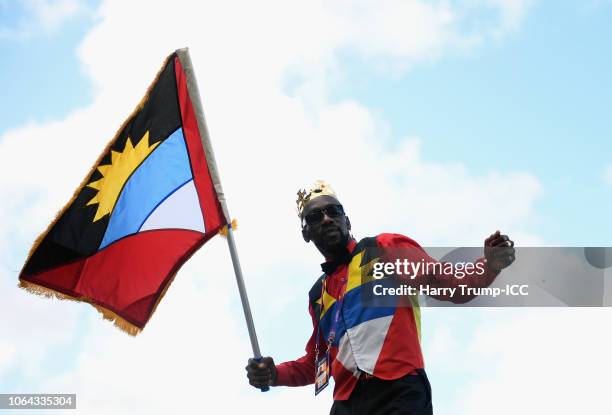 Spectator dances with a flag during the ICC Women's World T20 2018 Semi-Final match between West Indies and Australia at Sir Viv Richards Cricket...