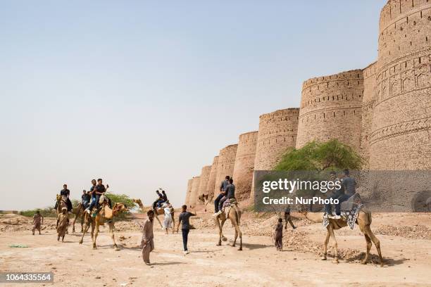 Bahawalpur, Pakistan, 5 October 2018. Tourists take a camel ride around Fort Derawar in the Cholistan desert where the walls have a perimeter of...