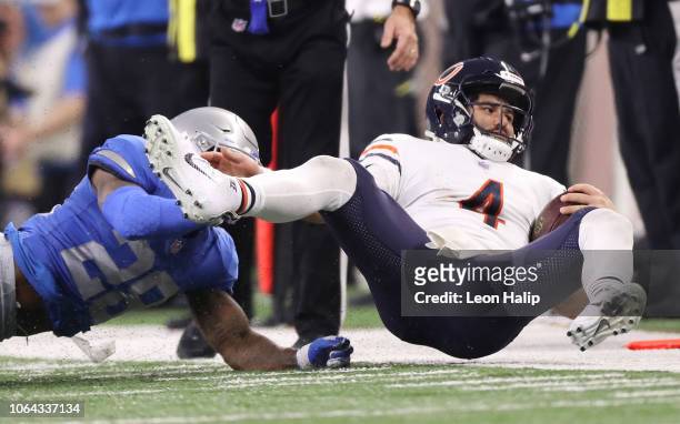 Quarterback Chase Daniel of the Chicago Bears is pulled down by Quandre Diggs of the Detroit Lions during the third quarter at Ford Field on November...