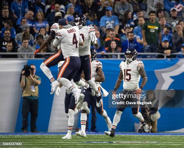 Defensive back Eddie Jackson of the Chicago Bears celebrates his interception for a touchdown in the fourth quarter with teammates quarterback Chase...