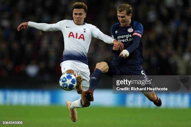 Dele Alli of Tottenham is challenged by Daniel Schwaab of PSV during the Group B match of the UEFA Champions League between Tottenham Hotspur and PSV...