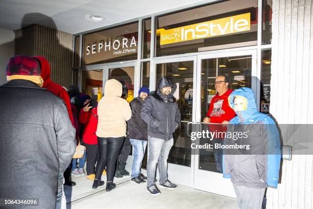 Shoppers stand in line waiting for a J.C. Penney Co. Store to open their doors in Garden City, New York, U.S., on Thursday, Nov. 22, 2018. Deloitte...