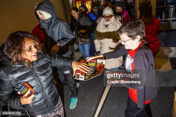 Shoppers receive Black Friday fliers and coupons at a J.C. Penney Co. Store in Garden City, New York, U.S., on Thursday, Nov. 22, 2018. Deloitte...