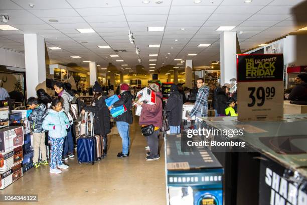 Shoppers stand in line at a J.C. Penney Co. Store in Garden City, New York, U.S., on Thursday, Nov. 22, 2018. Deloitte expects sales store from...