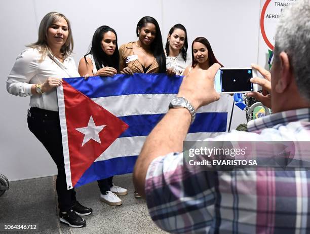 Group of Cuban doctors pose for a picture at Brasilia's airport, Brazil, before embarking and fly back to Cuba, on November 22, 2018. - The Cuban...