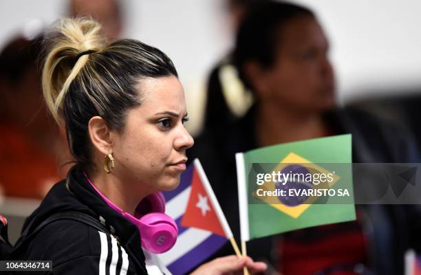 Cuban doctor waits to check-in at Brasilia's airport, Brazil, to fly back to Cuba, on November 22, 2018. - The Cuban government decided to withdraw...