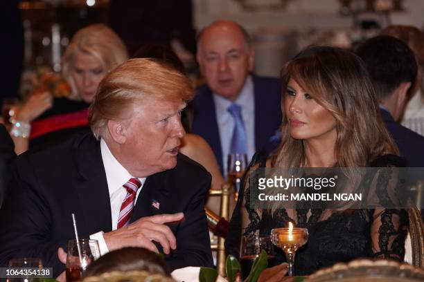 President Donald Trump and US First Lady Melania Trump sit down for Thanksgiving dinner at his Mar-a-Lago resort in Palm Beach, Florida on November...