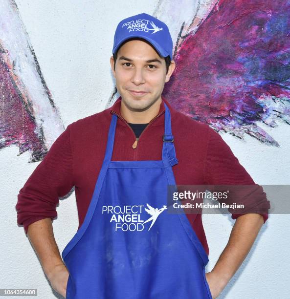 Skylar Astin poses with artwork by Colette Miller on Thanksgiving Day at Project Angel Food on November 22, 2018 in Los Angeles, California.