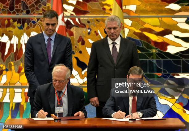 Cuba's President Miguel Diaz-Canel and Spain's Prime Minister Pedro Sanchez look on as Cuban Foreign Minister Bruno Rodriguez and his Spanish...