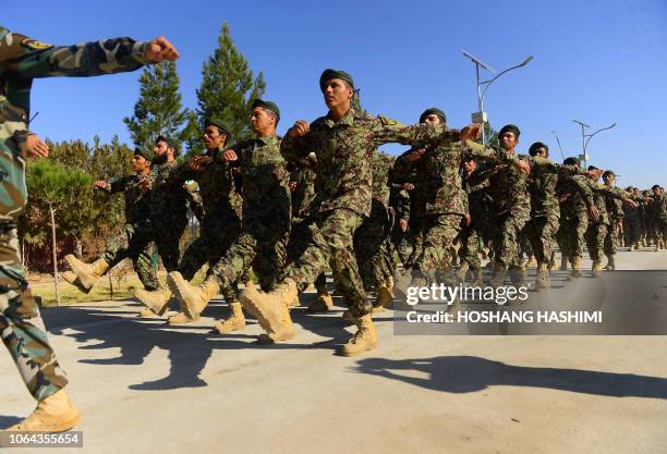 In this photo taken on November 19 newly-graduated Afghan National Army cadets march during a graduation ceremony at the ANA training centre in Herat...