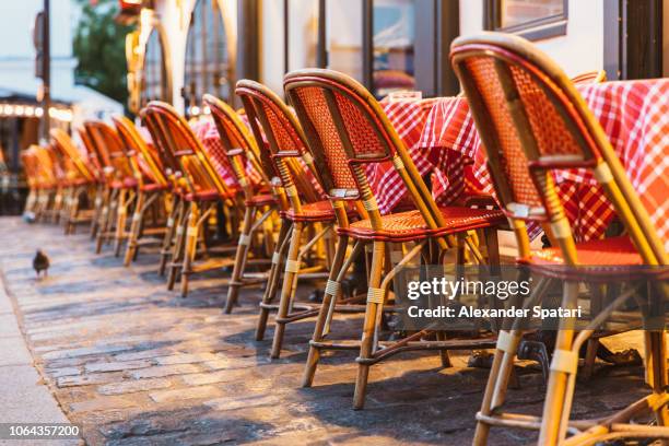 chairs and table at typical sidewalk cafe in paris, france - paris restaurant stock pictures, royalty-free photos & images