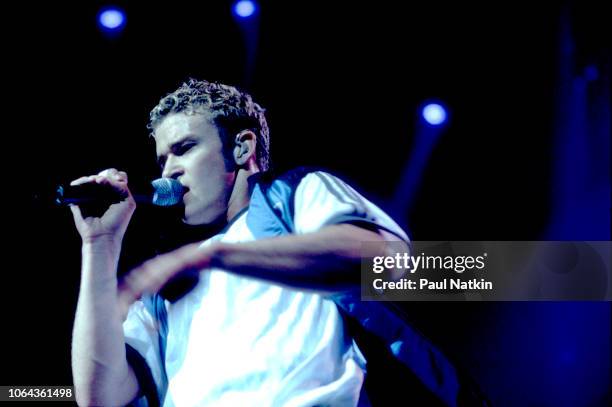 Justin Timberlake of the music group N'Sync perform on stage at the Rosemont Horizon in Rosemont, Illinois, March 26, 1999.