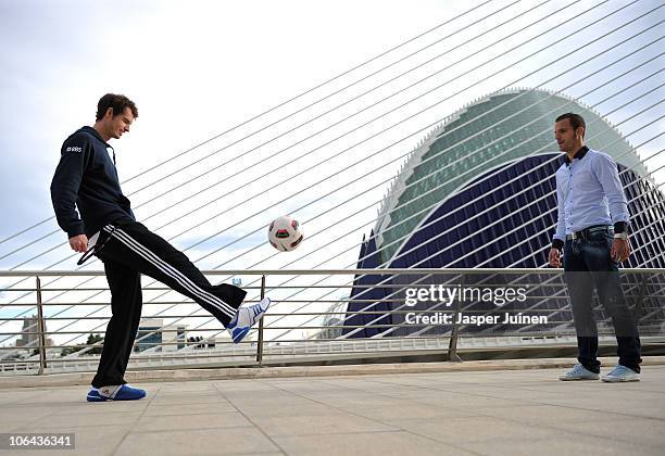 Andy Murray of Great Britain plays a ball to football player Roberto Soldado of Valencia during the ATP 500 World Tour Valencia Open tennis...