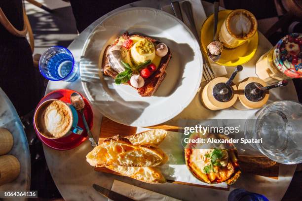 breakfast in cafe with french toast and baked eggs with chorizo, paris, france - pain perdu ストックフォトと画像