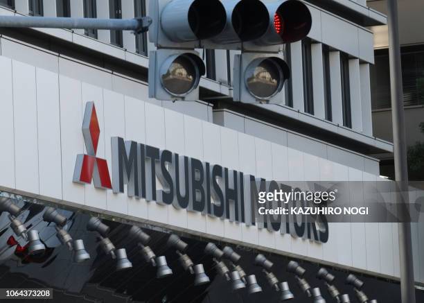 The logo of Mitsubishi Motors is seen at the headquarters of Mitsubishi Motors in Tokyo on November 23, 2018. - Nissan's board sacked Carlos Ghosn as...