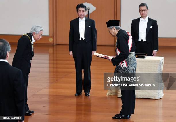 Malaysian Prime Minister Mahathir Bin Mohamad receives the Grand Cordon of the Order of the Paulownia Flowers from Emperor Akihito during the Grand...