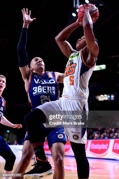 Devon Hall of the Taipans shoots for goal past Jacob Wiley of the Adelaide 36ers during the round seven NBL match between the Adelaide 36ers and the...
