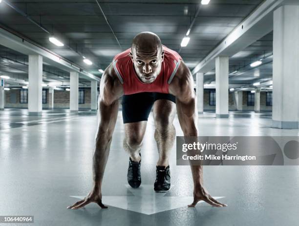 black male sprinter in starting position - out of context stock pictures, royalty-free photos & images