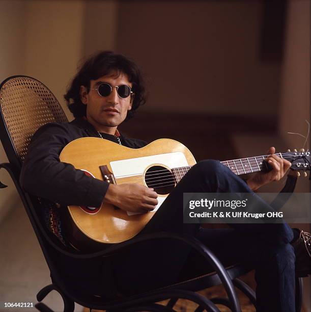 David Peel poses for a portrait playing acoustic guitar, circa 1968 in Germany.