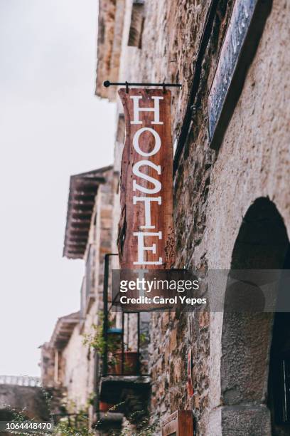 hostel sign in stone facade. pyreness village in spain - hostel stock pictures, royalty-free photos & images