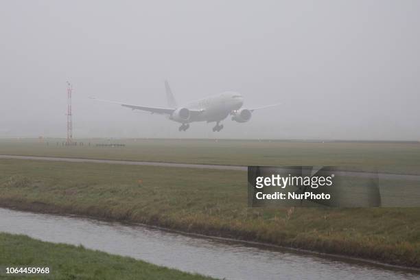 Saudi Arabian Airlines Boeing 777-FFG is landing in the mist in Amsterdam Schiphol Airport in The Netherlands. Saudia is the national airline carrier...