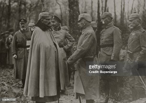 Portrait of Kaiser Wilhelm II of Germany and his brother Prince Henry of Prussia , along with unidentified others, as they meet at the edge of a...