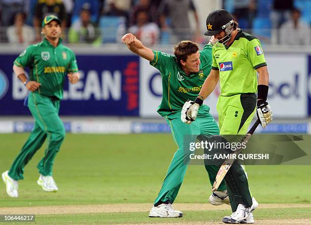 South African bowler Morne Morkel celebrates after taking the wicket of Pakistani cricket team captain Shahid Afridi during the third day-night...