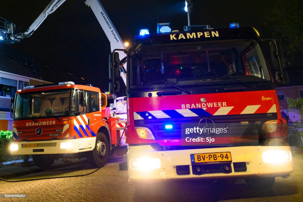 Fire engines of the Dutch fire brigadet at a chimney fire in a residential area