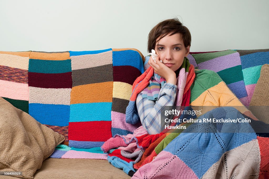 Woman looking ill on sofa