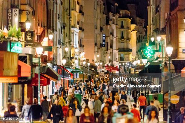 rue montorgueil pedestrian street with multiple restaurants and intense nightlife, paris, france - rue montorgueil stockfoto's en -beelden