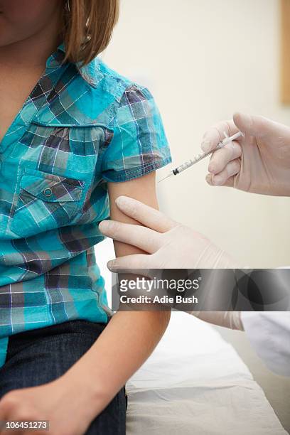 girl having injection - vaccine uk stock pictures, royalty-free photos & images