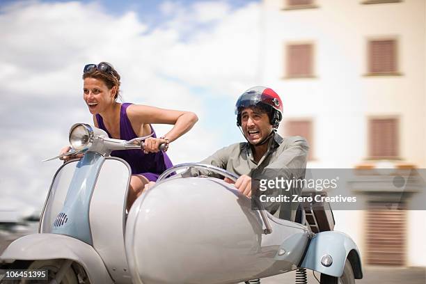 couple driving a vespa - motorbike sidecar stock pictures, royalty-free photos & images